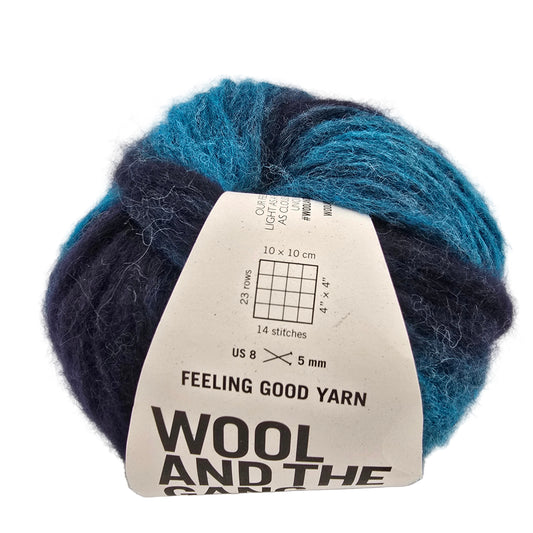 Image of a single ball of Feeling Good Yarn by Wool And The Gang in the color Northern Lights Green Stripe with label on a white background.