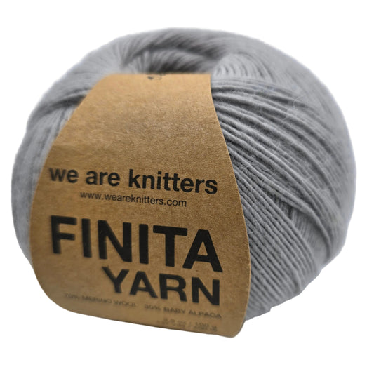 Image of a single ball of Finita yarn by We Are Knitters in Grey with label on a white background.