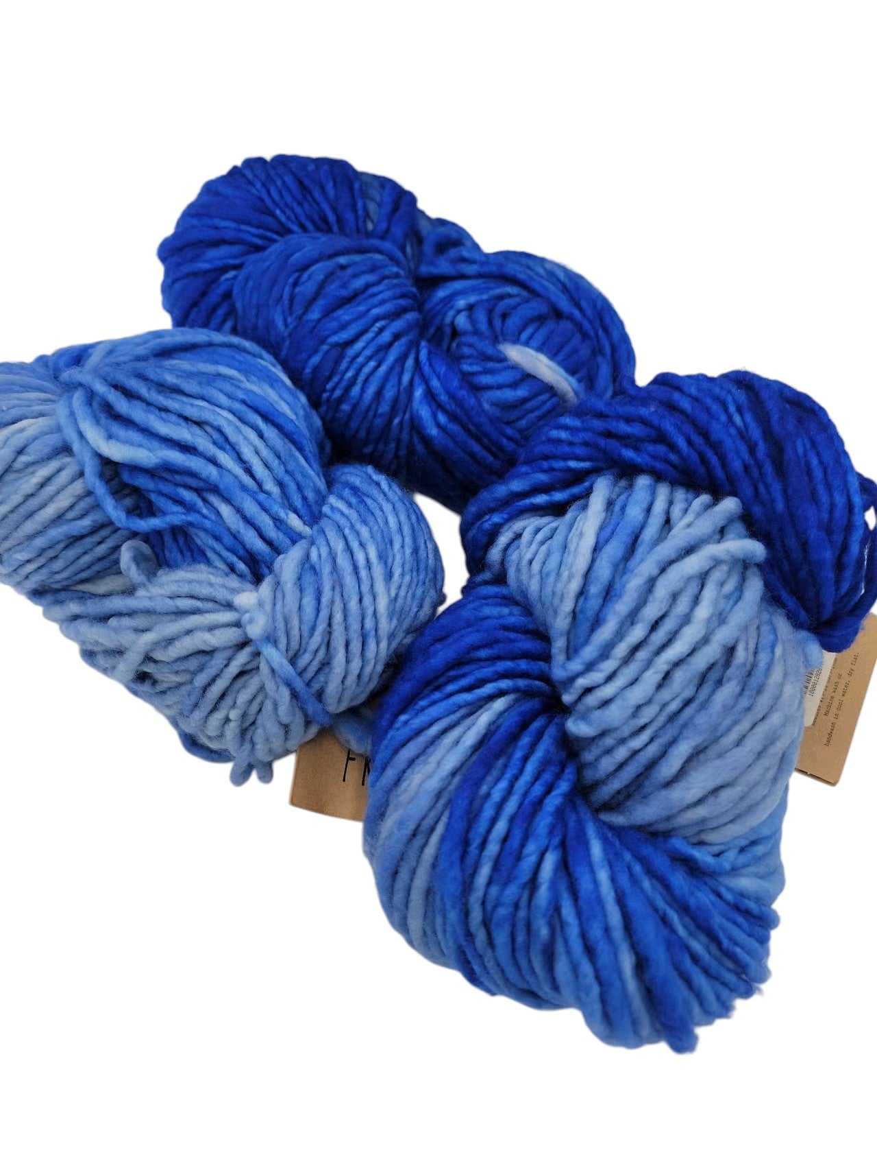 Three skeins of blue Franca by Manos del Uruguay yarn on a white background