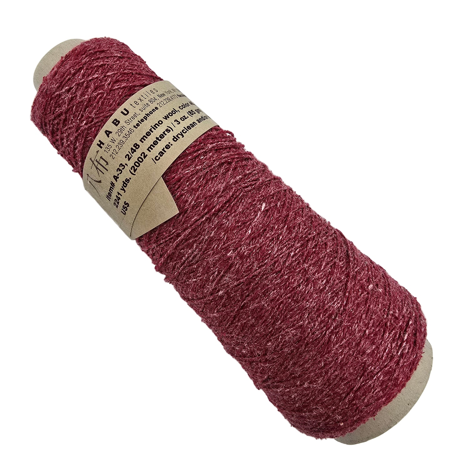 Spool of red Habu Textiles yarn with a label on a white background