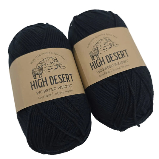 Image of two skeins of High Desert Worsted Yarn by Knit Picks in the color Lava Fields with labels on a white background.