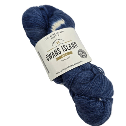 Image of a single skein of Ikat Collection Firefly Yarn by Swans Island in the color Firefly Prussian Blue IFF203 with label on a white background.
