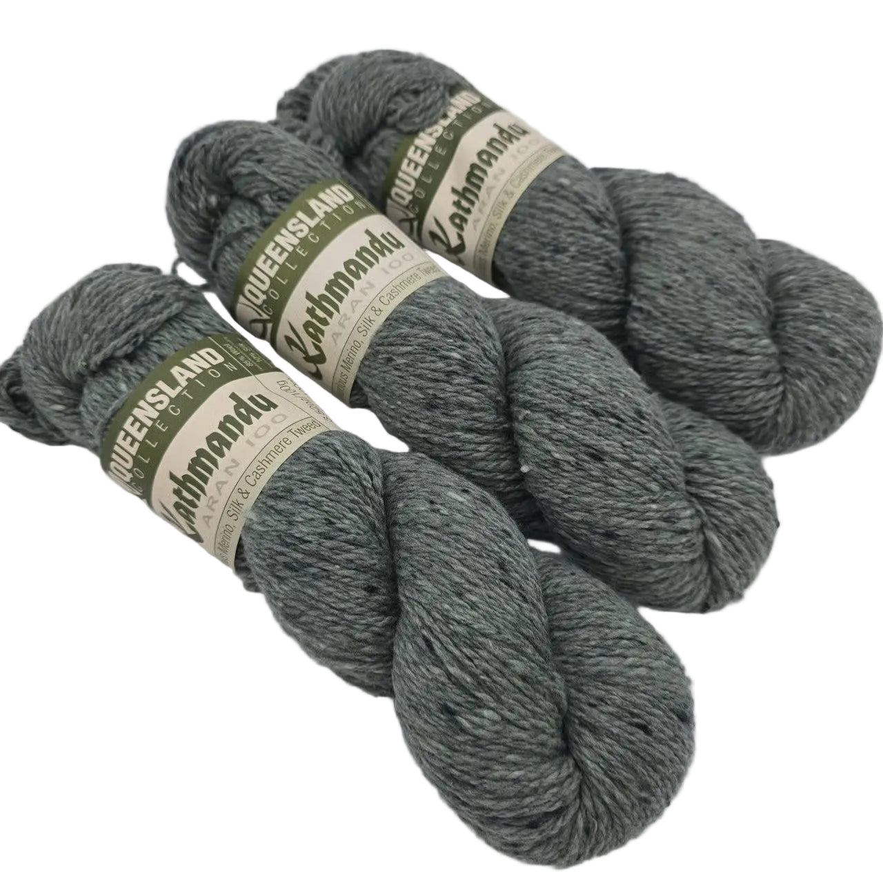 Image of three skeins of Kathmandu_Aran_100_yarn by_Queensland_Collection_in Color_2_Slate_Gray with labels in a white background.