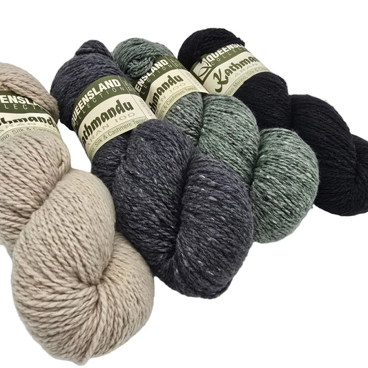 Four skeins of Kathmandu Aran 100 yarn by Queensland Collection in different colors with labels on a white background.
