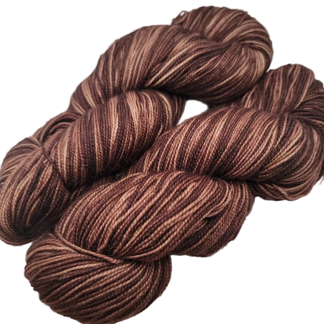 Image of two skeins of Knit Picks Hawthorn Fingering Yarn in the color Faun Kettle Dye on a white background.