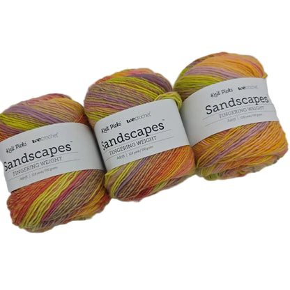 Image of 3 cakes of Knit Picks Sandscapes in the color Adrift with labels on a white background.