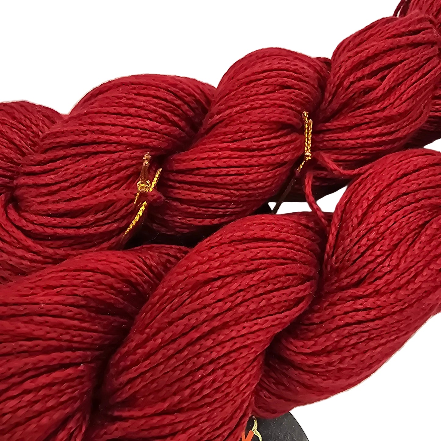 Close-up image of Two Skeins of red lily by Noro Yarn in Color 24 with label on a white background.