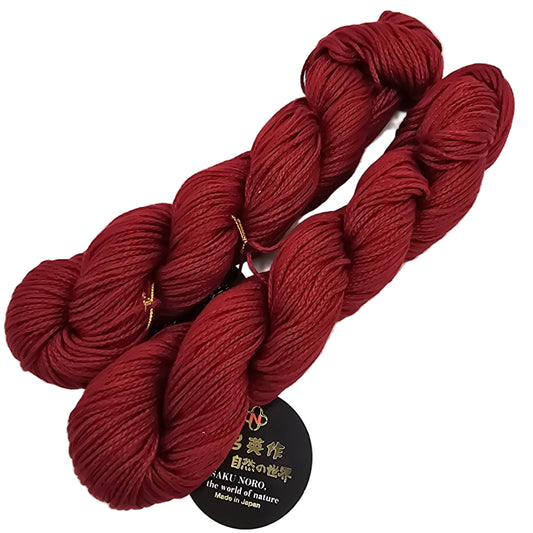 Two Skeins of red lily by Noro Yarn in Color 24 with label on a white background.