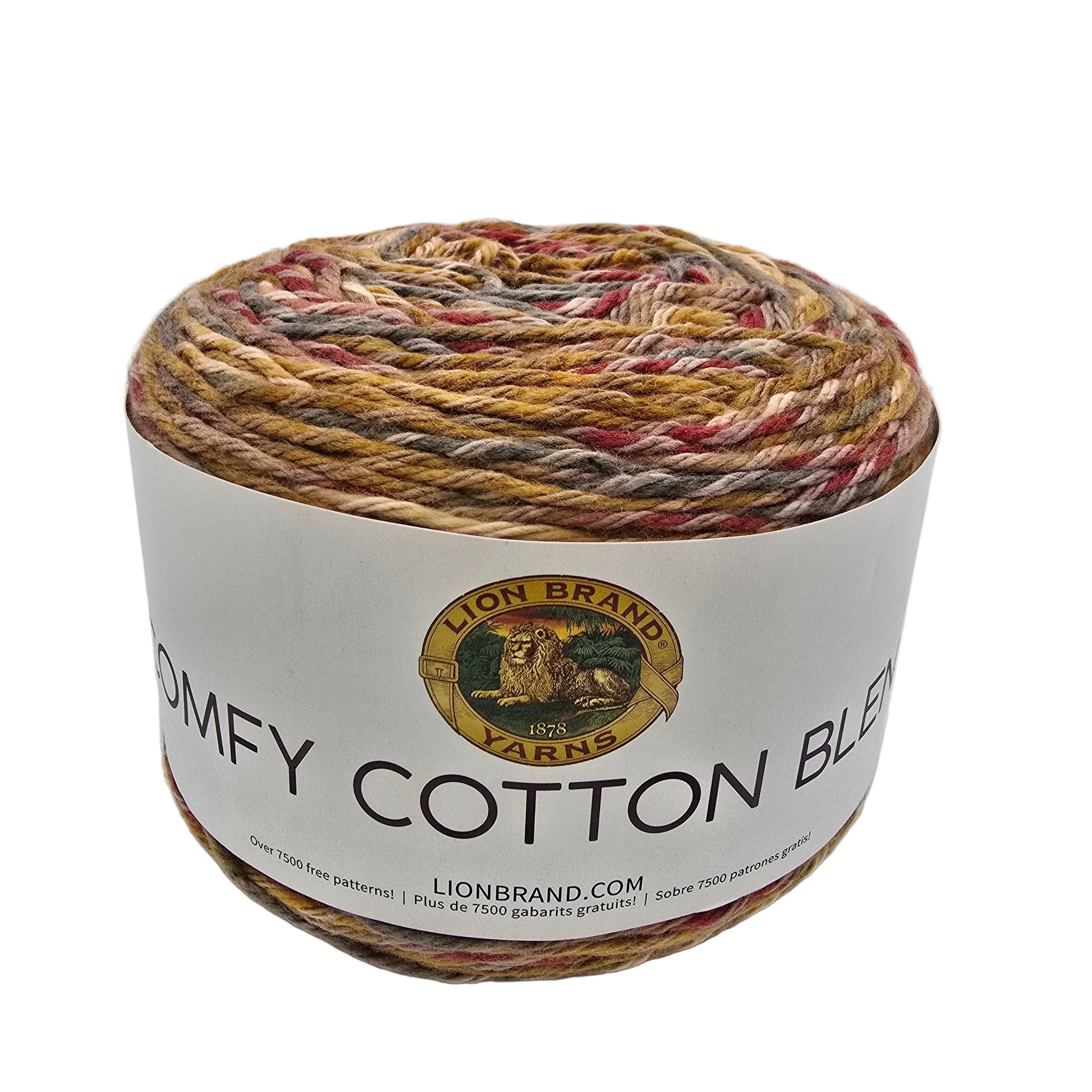 A ball of Lion Brand Comfy Cotton Blend yarn in the color fireside with a white paper label, showing a variegated blend of beige, brown, red, and cream colors.