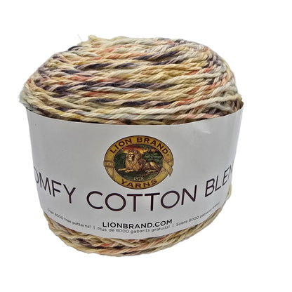 Image of a single cake of Lion Brand Comfy Cotton Blend Yarn  in the color  Chai Latte  with label on a white background.