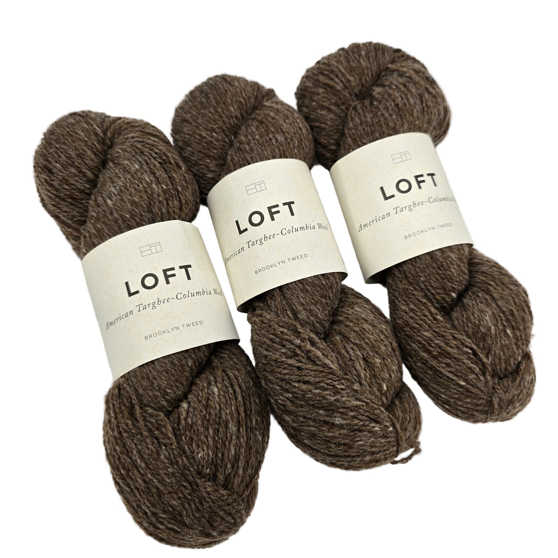 Image of three skeins of Loft by Brooklyn Tweed yarn in the color nest with labels on a white background.