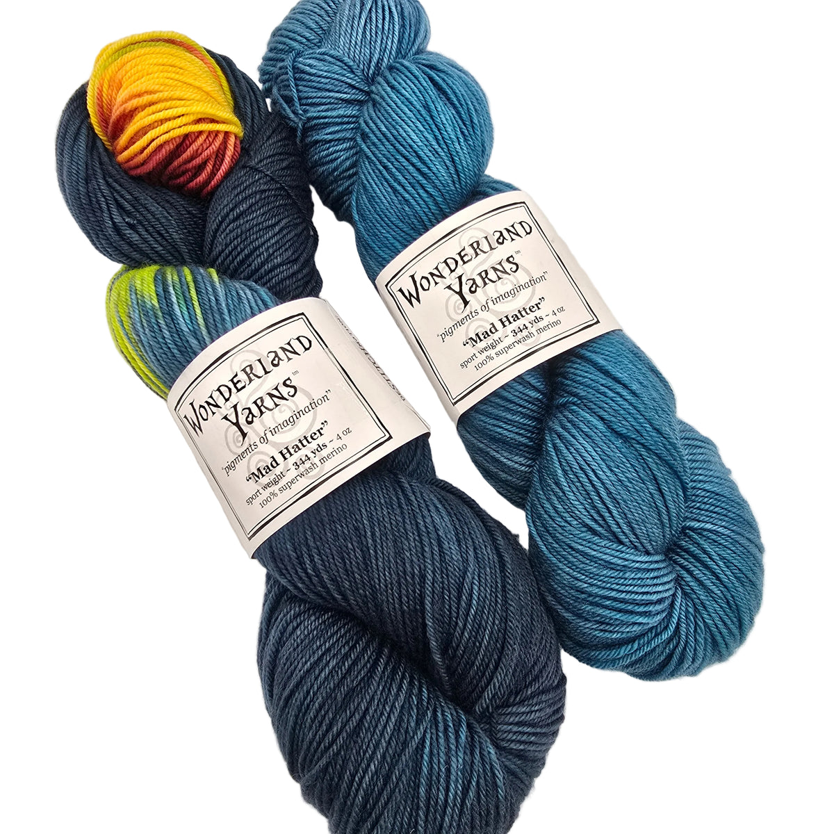 Two skeins of Wonderland Yarns Mad Hatter DeSTITCHnation yarn on a white background. One skein is a dark navy blue, and the other is a bright teal blue.