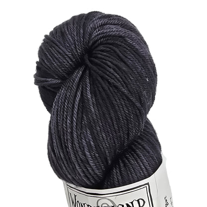 Dark gray skein of yarn with a label on a white background