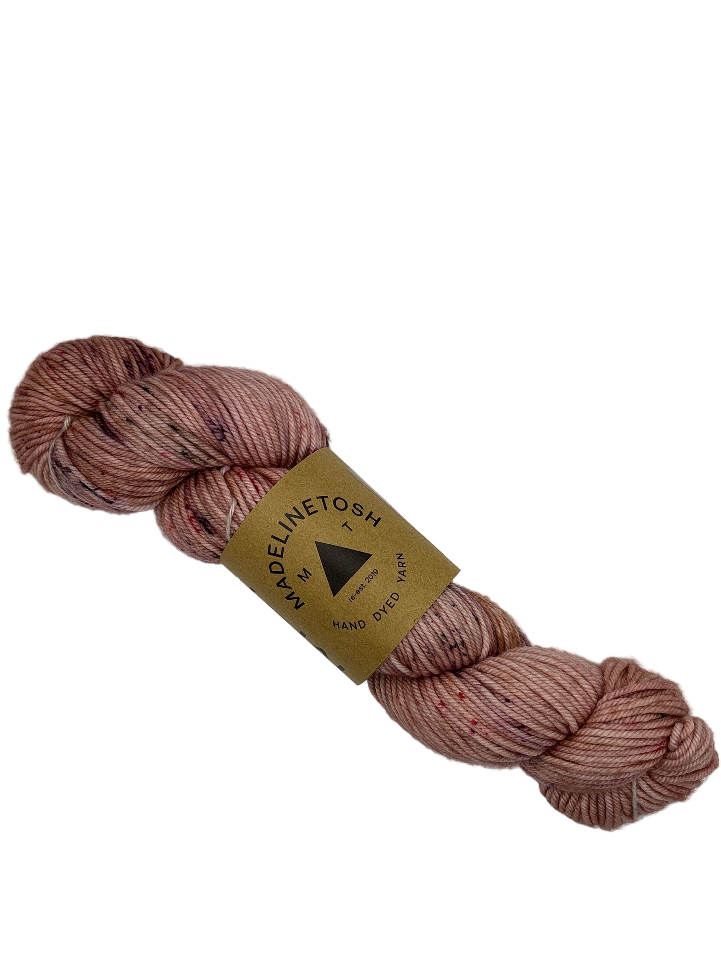 Skein of pink Madelinetosh yarn with a label on a white background