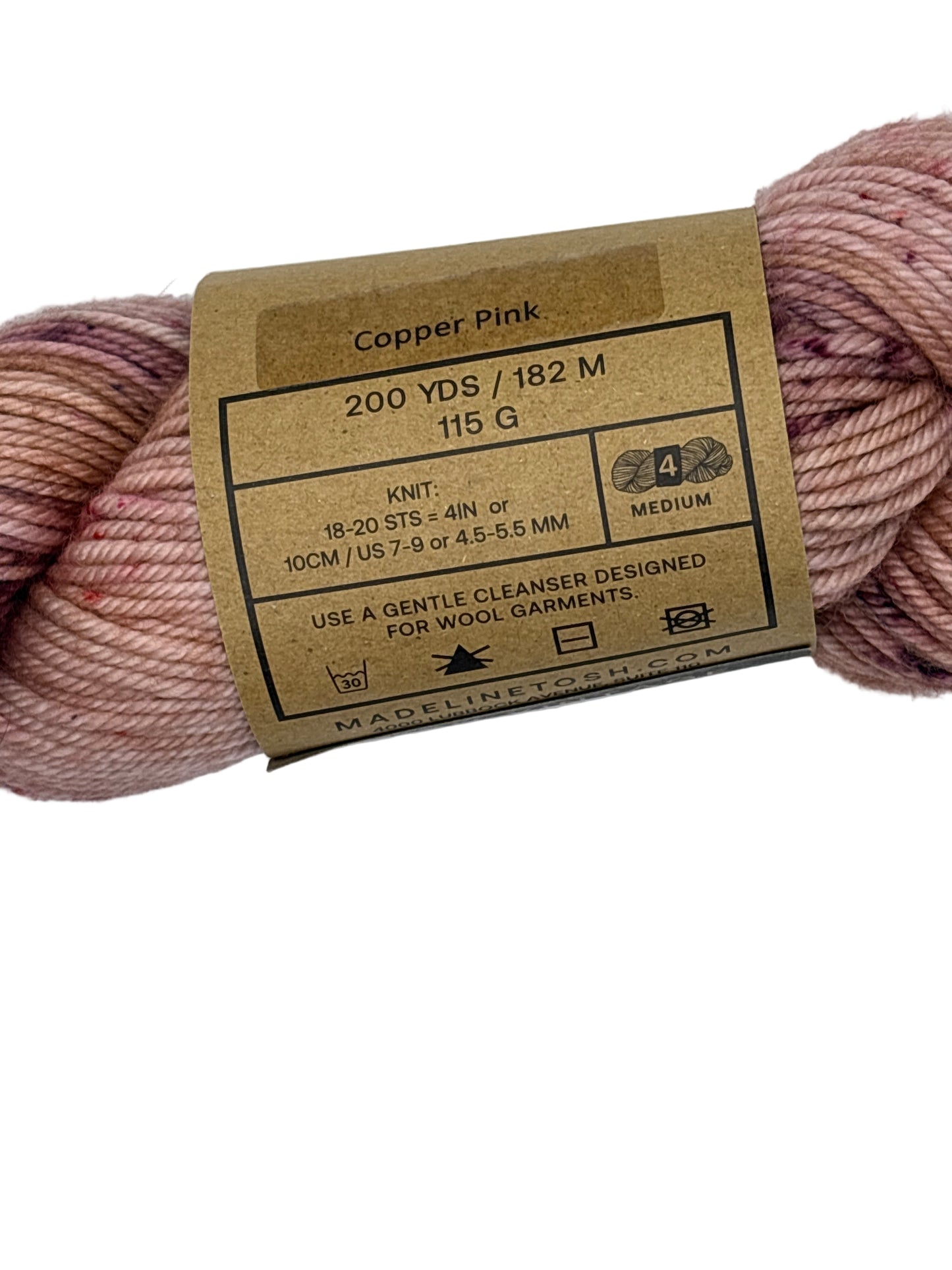 Skein of pink yarn with a label on a white background