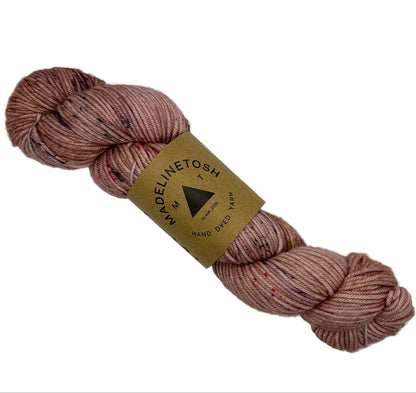 Image of a singel Skein of Madelinetosh_Tosh_Vintage_Yarn_-in the color Cooper_Pink with a label on a white background.