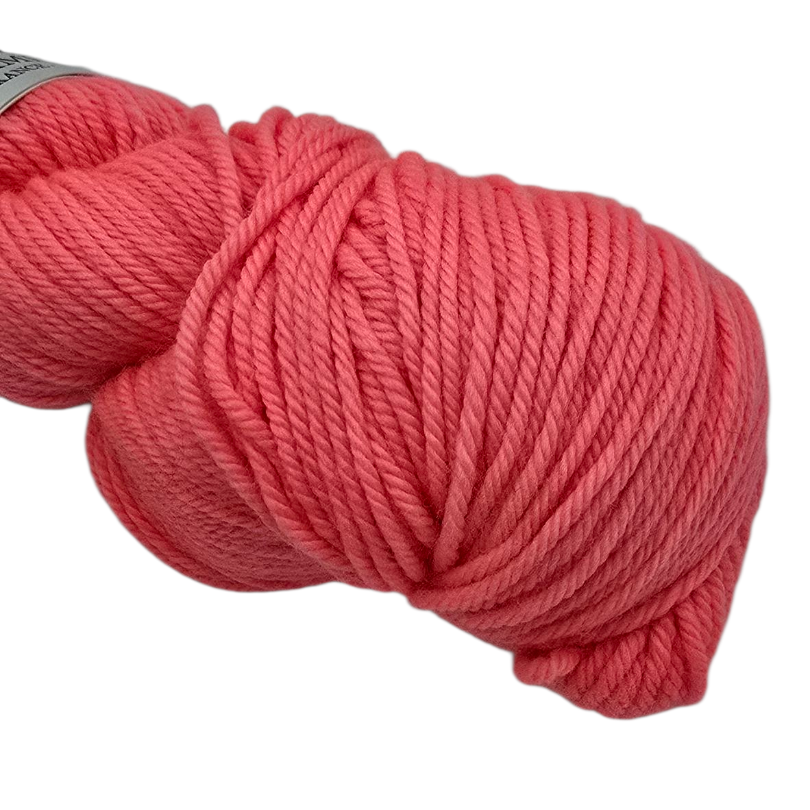 Close-up image of a single skein of Merino DK by La Bien Aimee yarn in color Fluoro Morganite (Salmon pink) on  a white background.
