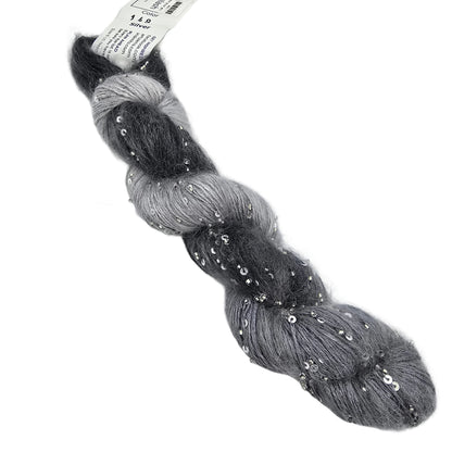 A skein of Mohair Splash yarn by ArtYarns  in color 148 Silver which is a gray ombre yarn with silver sequins, featuring a white paper label at the top, photographed on a white background.