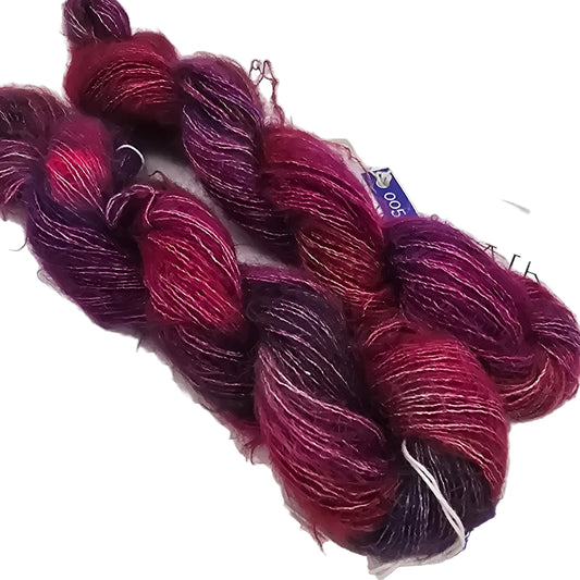 Image of Two Skeins of Mohair yarn by Malabrigo in color Aniversario on a white background.,