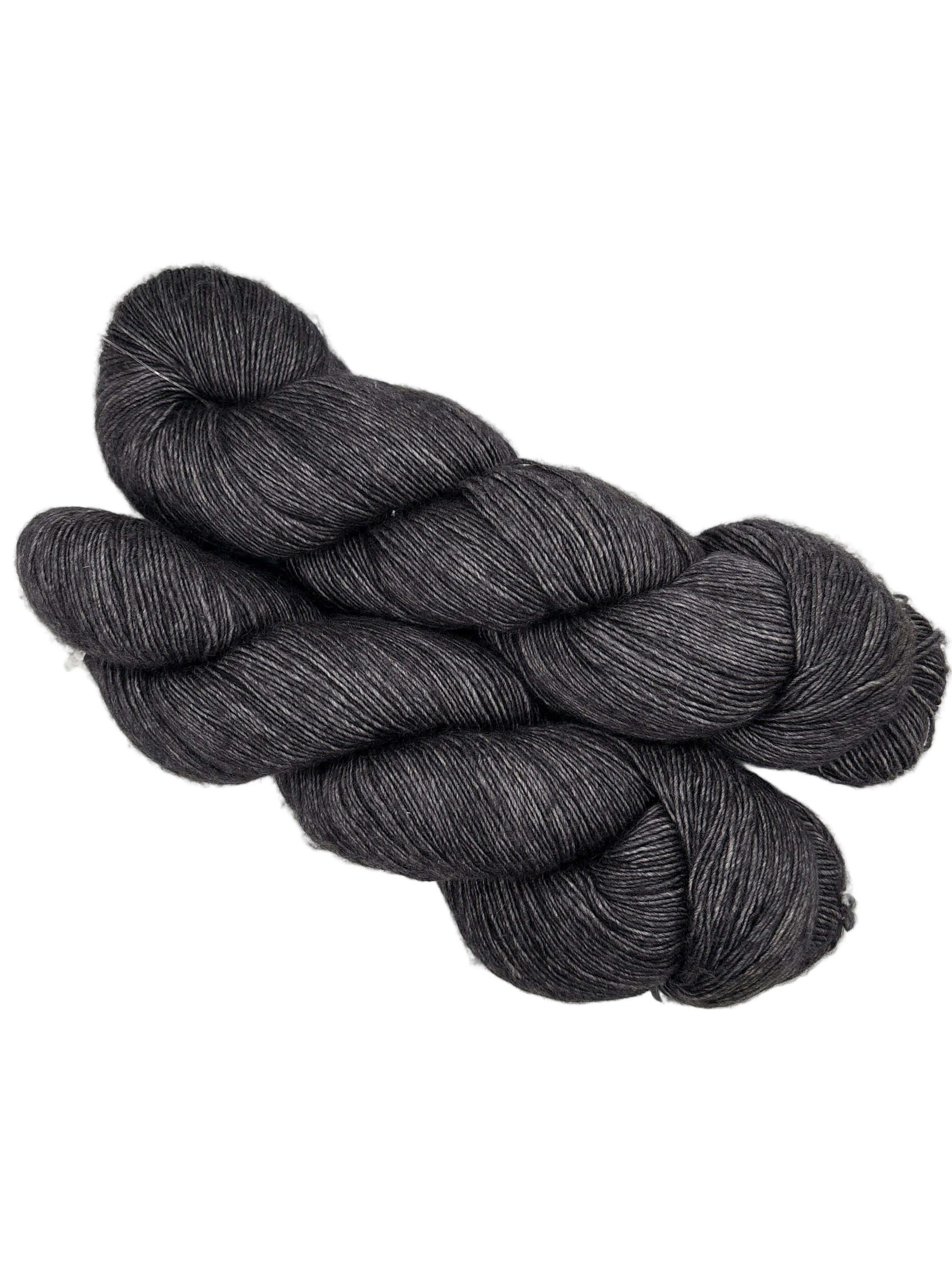 Two Skeins of Monologue by Leading Men Fiber Arts Yarn in the color Don’t Fear the Reaper on a white background.