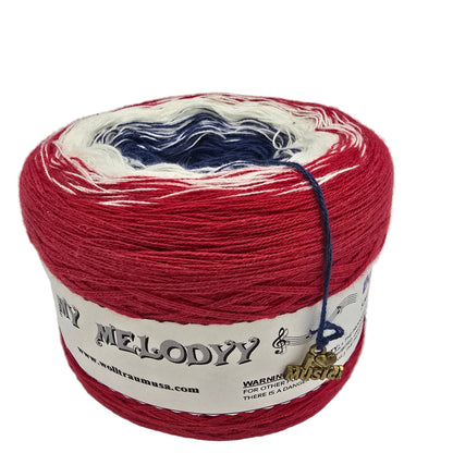 A cake of variegated yarn with red, white, and navy blue color sections, wrapped in a white paper label on a white background.
