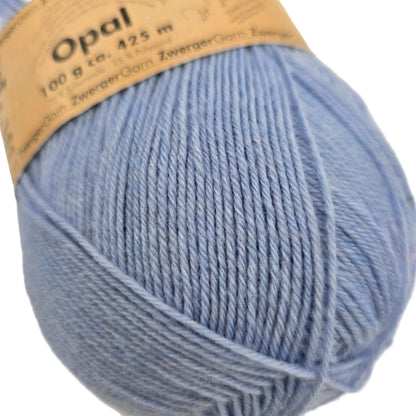 Close-up image of Opal Uni Solid 4-Ply yarn by Opal in Color 27 with partial label on a white background.