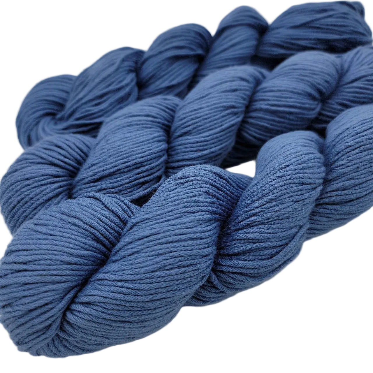Image of 3 skeins of Organic Cotton Skinny Yarn by Blue sky Fibers in the color Blue Bell on a white background.