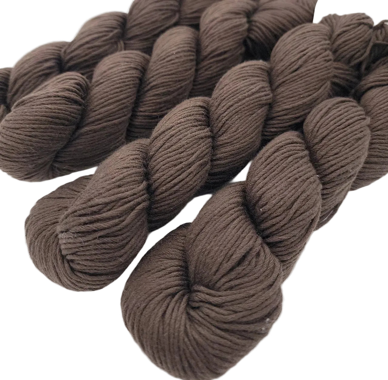 Image of 4 skeins of Organic Cotton Skinny Yarn by Blue Sky Fibers in the color coffee on a white background.