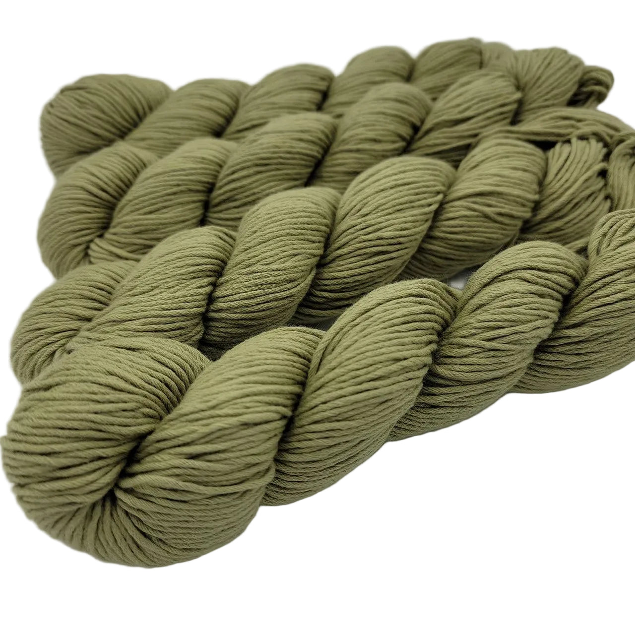 Image of 4 skeins of organic cotton skinny yarn by blue sky fibers in color number 312 pear on a white background.