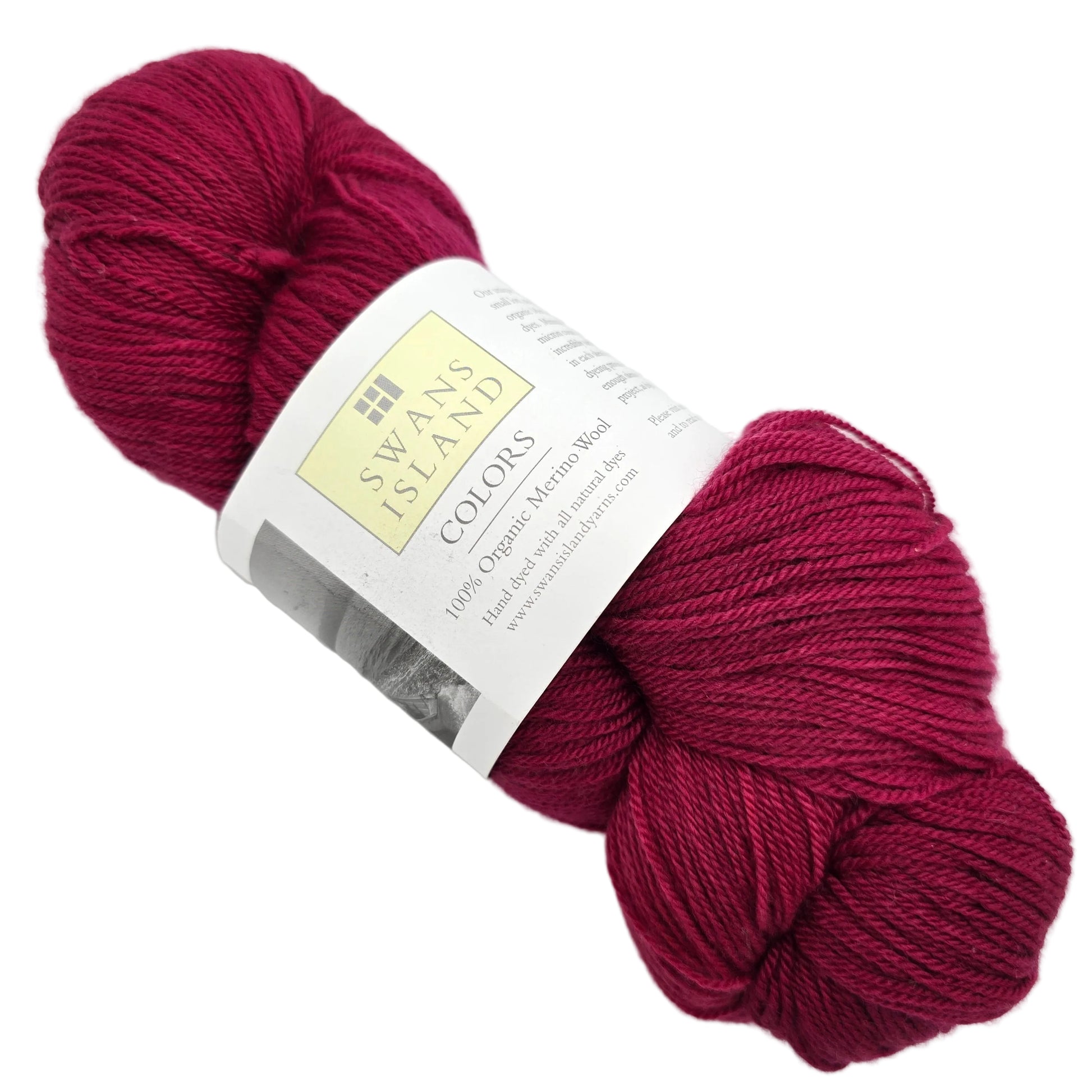 Image of a single skein of Organic Merino yarn by Swans Island in the color Garnet YF101 with label on a white background.