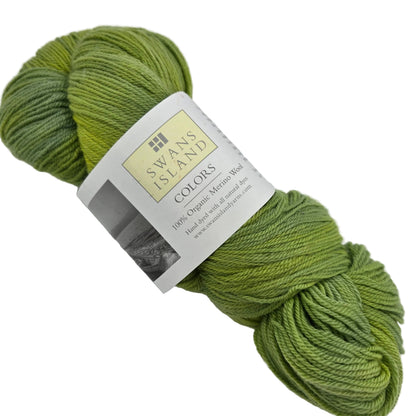Image of a single skein of Organic Merino by Swans Island Yarn in the color Spring Green YF109 with label on a white background.