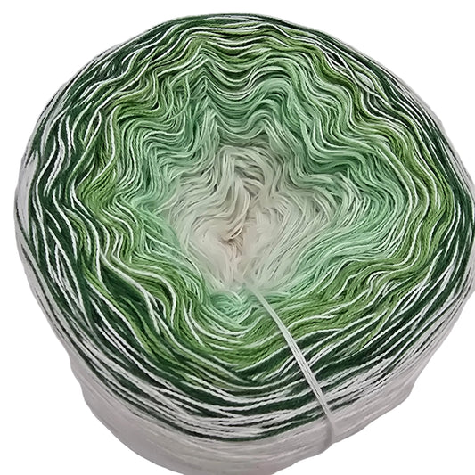 Overhead Image of a single cake of Little Favorite Yarn by Rea in the color Frozen Greens with label on a white background.