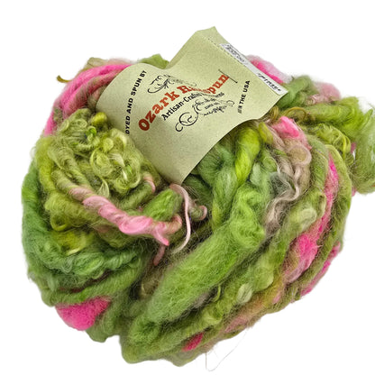 Image of a single ball of Ozark Opulent II Yarn by Ozark Handspun with label on a white background.