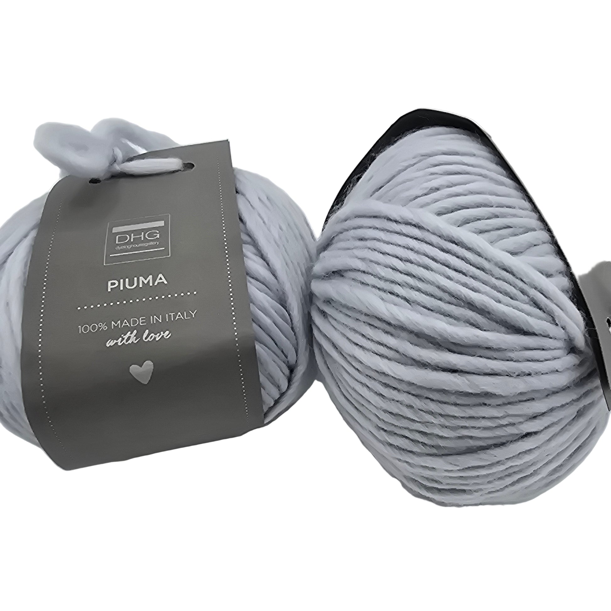 Image of two balls of Piuma by DHG Ultra Soft bulky Italian Merino Wool  yarn in the color cloud which is a solid pale bluish grey with labels on a white background