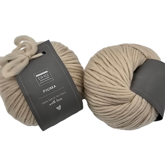 Image of two balls of Piuma by DHG Ultra Soft bulky Italian Merino Wool  yarn in the color Earth which is a solid light grey/beige with labels on a white background