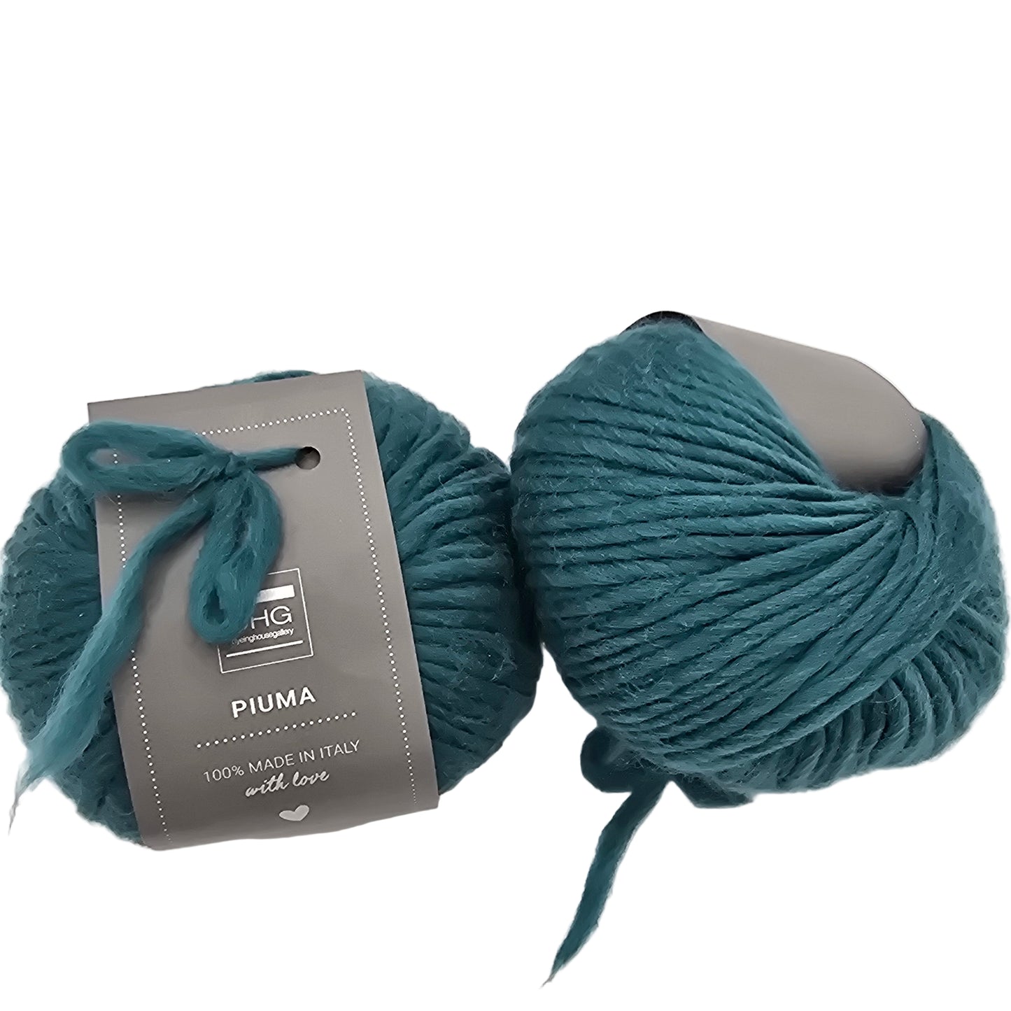 Image of two balls of Piuma by DHG Ultra Soft bulky Italian Merino Wool  yarn in the color Ireland which is a solid dark teal green with labels on a white background