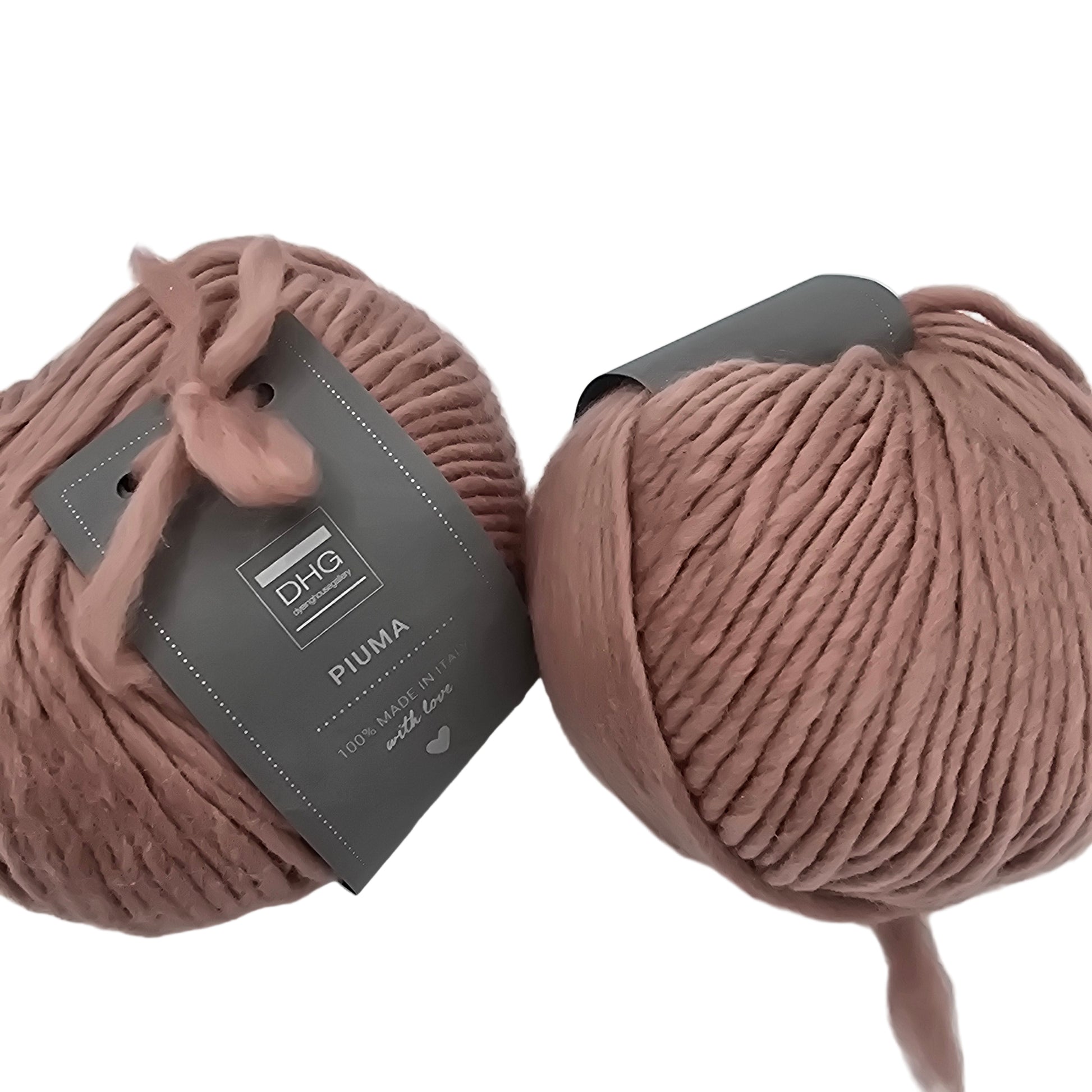 Image of two balls of Piuma by DHG Ultra Soft bulky Italian Merino Wool  yarn in the color Lace which is a solid Mauve with labels on a white background