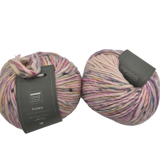Image of two balls of Piuma by DHG Ultra Soft, bulky, Italian, Merino Wool  yarn in the color Macaron which is a multicolor yarn with mixed pastel colors on a pale pink base with labels on a white background.
