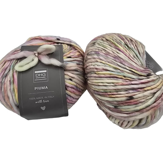 Image of two balls of Piuma by DHG Ultra Soft, bulky, Italian, Merino Wool  yarn in the color Marshmallow which is a multicolor yarn of mixed pastels on a white base with labels on a white background.