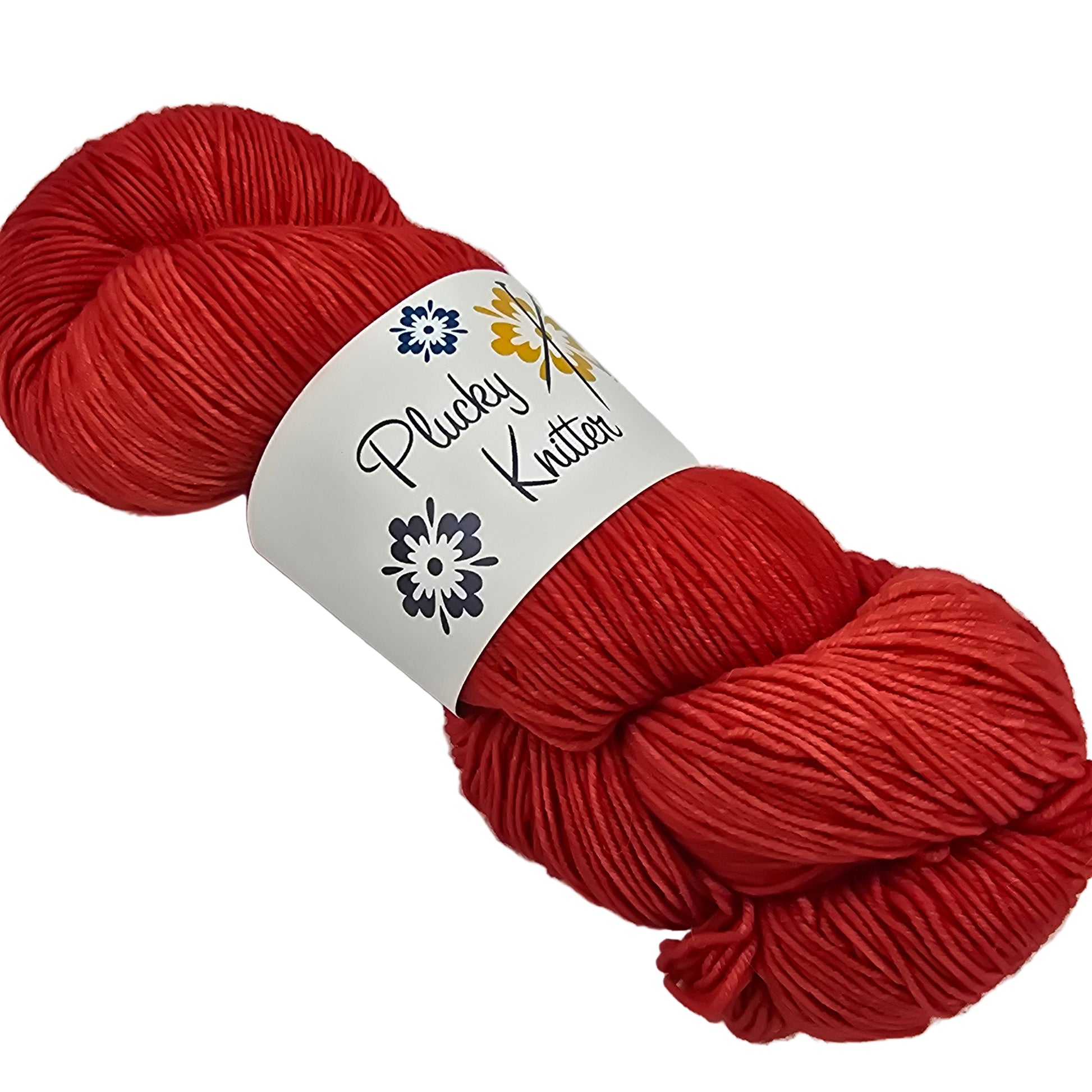 Image of a single skein of Plucky Knitter Merino-Nylon Blend yarn in the color King Salmon which is red with a label on a white background.