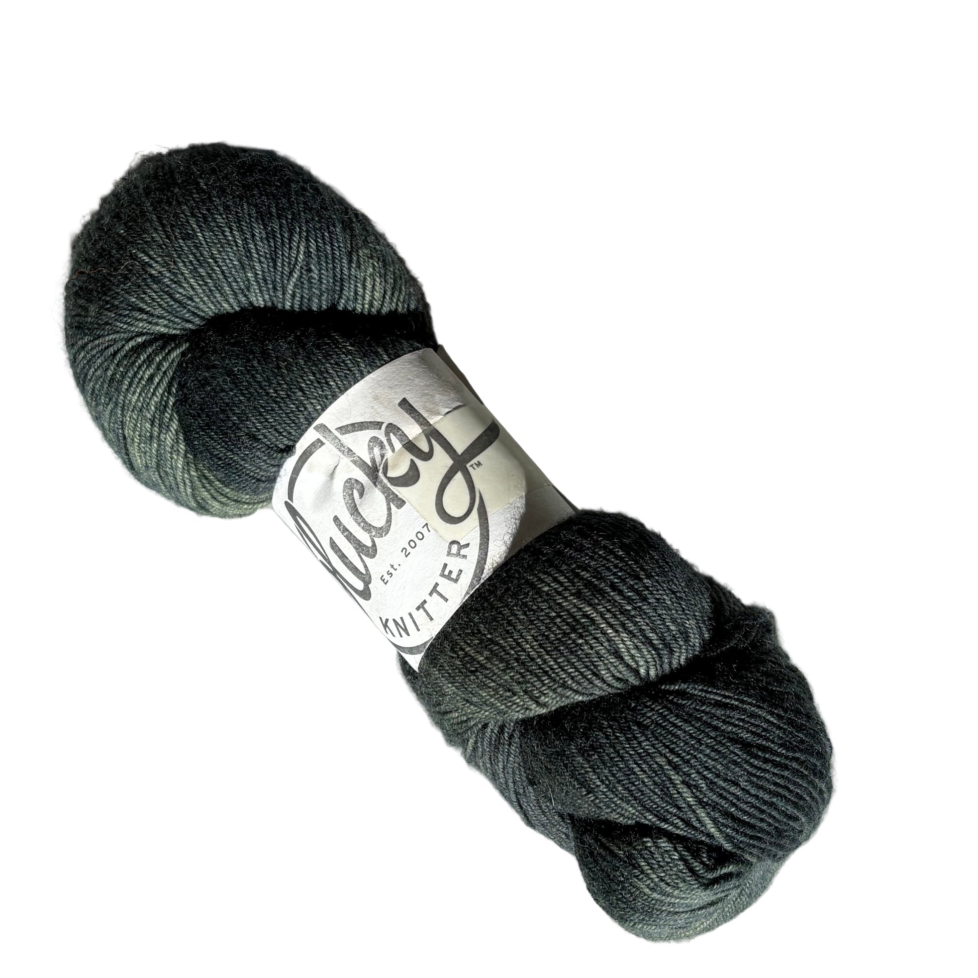 Image of a single skein of Kraken, a dark grey and green, Fingering weight yarn from Plucky Knitter with label on a white background.