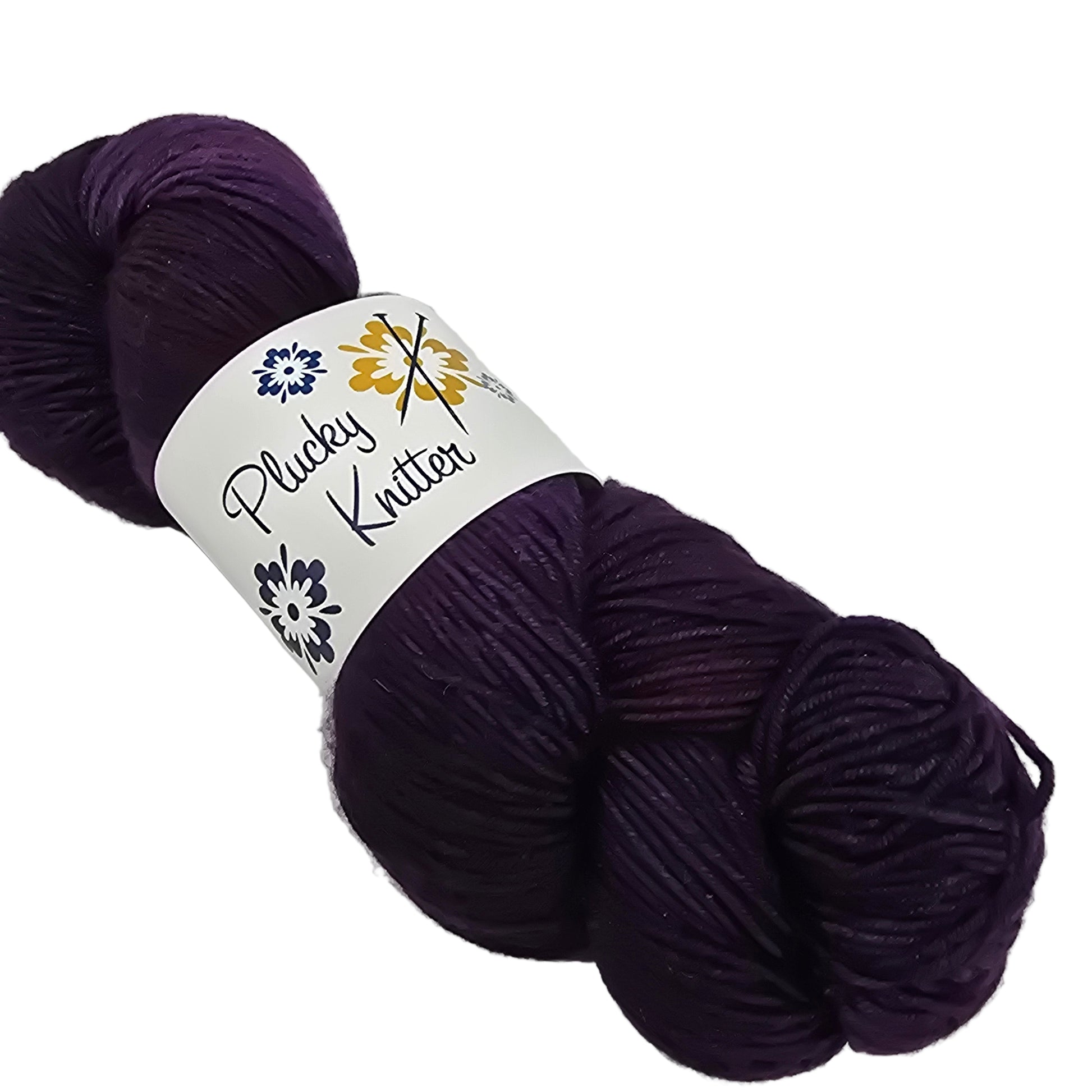 Image of a single skein on yarn by the brand Plucky Knitter in the color Vignette (which is dark purple) with label on a white background.