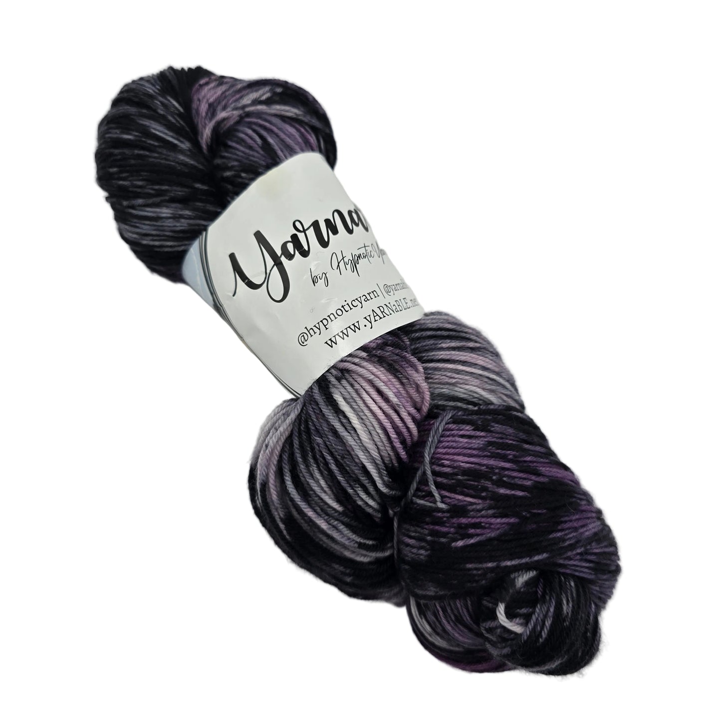 Image of a single hank of Plush Sock yarn by Hypnotic Yarn in the color Storm Watch with label on a white background.