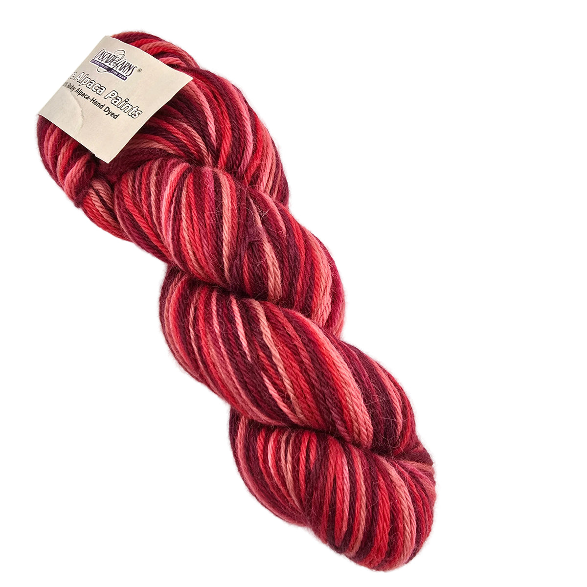 A skein of variegated yarn in shades of red, pink, and deep burgundy, with a paper label attached, photographed on a clean white background.