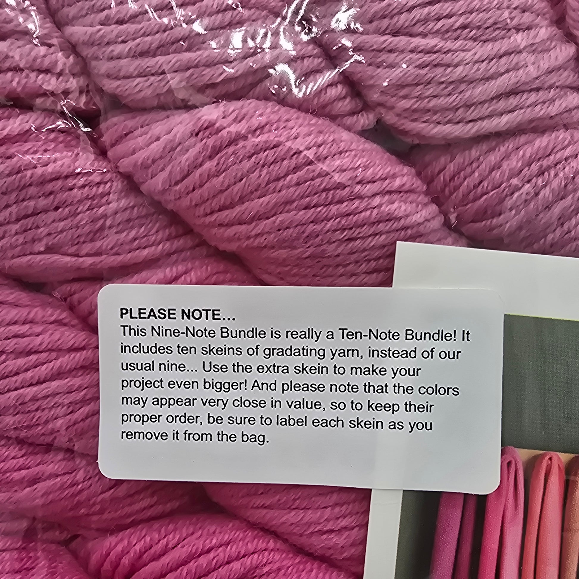 Close-up image of label on Nine-Note Bundle of Purl Soho Yarn in the color Dragon Fruit which is a pink gradient.