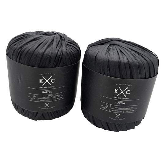 Image of two flat pull skeins of Raffia by Yarn K+C in black with labels on a white background.