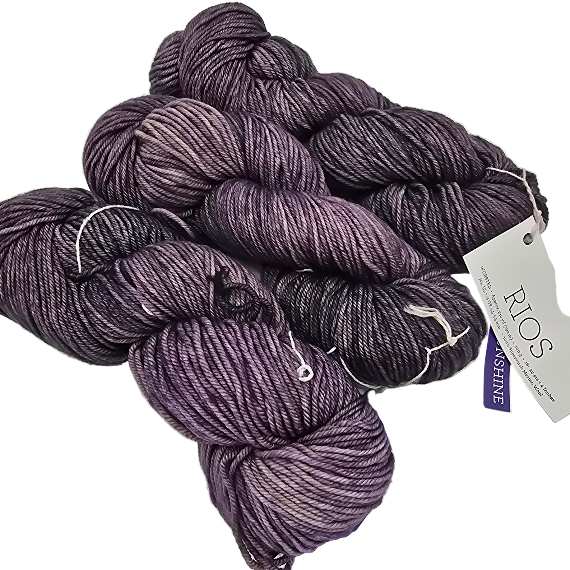Image of three skeins of Dark Purple worsted Merino Wool Rio by Malabrigos  Yarn with label on a white background.