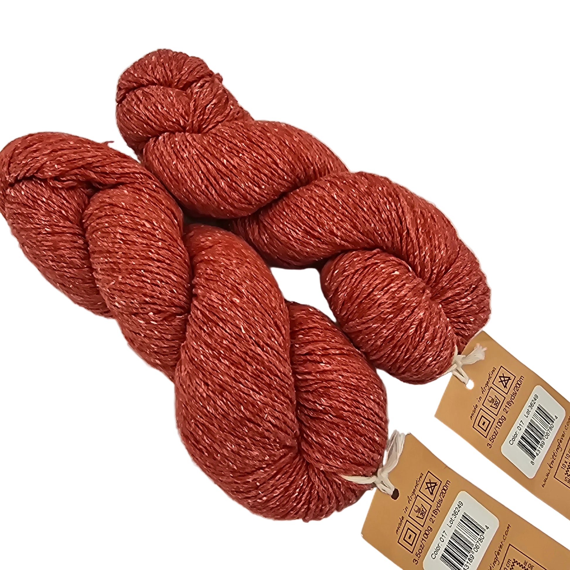 Three skeins of rust-colored yarn with tags on a light gray background