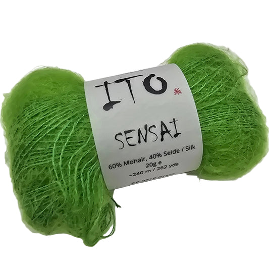 Image of a single hank of Sensai Yarn by Ito in the color grass with label on a white background.
