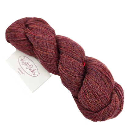 Image of a single skein of Shadow Heathered Yarn by Knit Picks in the color shadow sunset with label on a white background.